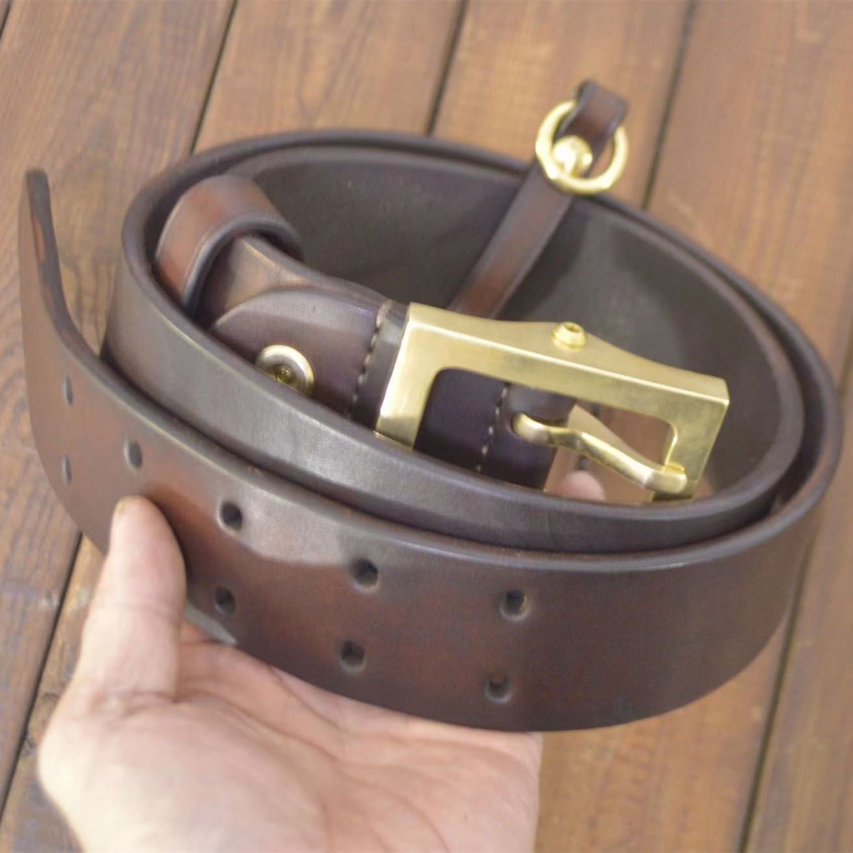 gold-buckle leather belt